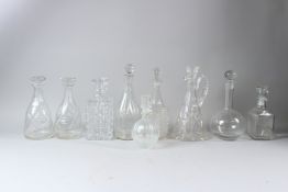 A PAIR OF CUT GLASS DECANTERS; together with seven other decanters and a claret jug (9).
