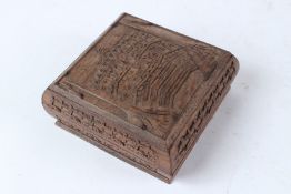 AN INDIAN HAND CARVED VINTAGE WOODEN JEWELLERY BOX. 13cms wide.
