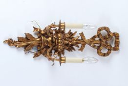 A CARVED WOOD AND GILDED SINGLE BRANCH WALL APPLIQUE, with ribbon and bow decoration. 61cms high x