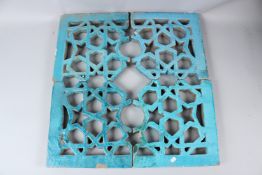 A 19TH CENTURY ISLAMIC, POSSIBLY INDIAN, OPEN WORKED TILE PANEL depicting geometric designs. Each