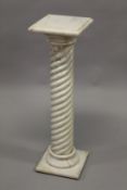 A WHITE MARBLE COLUMN, the square shaped top supported on a wrythen fluted column with moulded socle