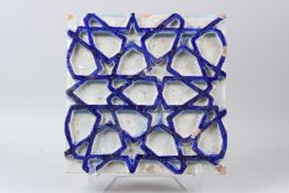 A FINE LARGE 18TH-19TH CENTURY INDIAN MULTAN GLAZED TILE with raised geometric designs. 33cms x