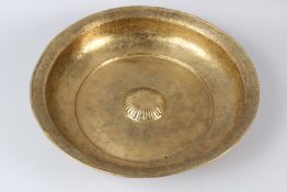 A LARGE GILT COPPER TOMBAK HAMMAM WASH BASIN, engraved with fish and stylised decoration. 46cms