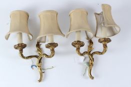 A PAIR OF ROCOCO STYLE ORMOLU TWIN-BRANCH WALL APPLIQUES, complete with shades. 24cms high x 19cms