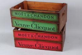 A PAIR OF WOODEN CHAMPAGNE CRATES. 44cms long.