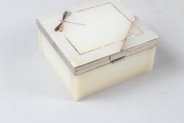 AN ART DECO ONYX AND SILVER MOUNTED BOX, inlaid with a dragonfly. 10.5cms wide.