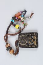 A TIBETAN AVALOKITESHVARA AUSPICIOUS HARDSTONE. Stone: 7cms. Total Length: 35cms.