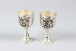 A PAIR OF CHINESE WHITE METAL DRAGON CUPS. 8cms (2).