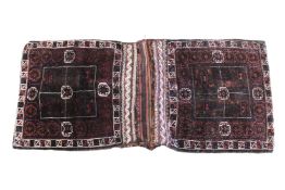 TWO ANTIQUE HORSE BAGS HAND KNOTTED RUGS, stitched together. 190cms x 82cms.