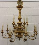 AN ORNATE GILTWOOD TWO-TIER, TWELVE-BRANCH CHANDELIER. 90cms diameter.