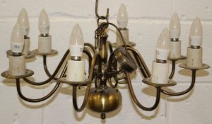 A DUTCH STYLE PATINATED BRASS EIGHT-BRANCH CHANDELIER. 62cms diameter.