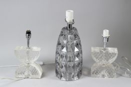 A STYLISED MOULDED GLASS TABLE LAMP; together with a pair of cut glass table lamps. 36cms and