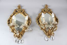 A PAIR OF ORMOLU, GILTWOOD AND CUT GLASS TWIN-BRANCH WALL GIRANDOLES. 50cms high x 34cms wide.