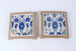 A PAIR OF BLUE AND WHITE IZNIK POTTERY TILES, TURKEY. 26cms x 26cms including frame.
