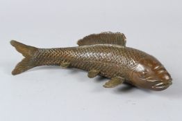 A BRONZE AND GILT BRONZE TABLE SALT, modelled as a cherub on a shell. 14cms wide.