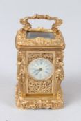 A MINIATURE CAST AND GILDED METAL CARRIAGE CLOCK. 9cms high.