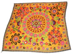AN UZBEK SUZANI TEXTILE, orange ground with a floral embroidered design. 185cms x 190cms.