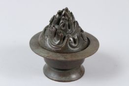 A CHINESE BRONZE INCENSE BURNER. 10cms tall. Under mark to the base.