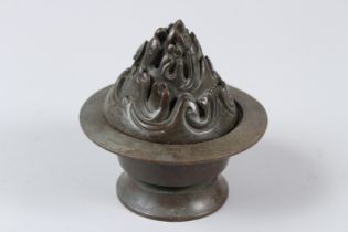 A CHINESE BRONZE INCENSE BURNER. 10cms tall. Under mark to the base.