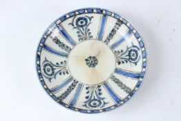 A 19TH CENTURY SAVAFID POTTERY DISH, IRAN. 25.5cms diameter.