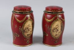 A PAIR OF RED TOLEWARE STYLE JARS AND COVERS. 17cms high.
