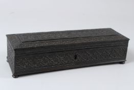 A FINELY ENGRAVED 19TH CENTURY INDIAN EBONY PEN BOX. 28cms x 9cms.