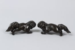 A PAIR OF CHINESE SILVER INLAID FO DOGS, C1900, tails detached.