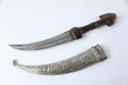 A FINE 19TH CENTURY OTTOMAN DAGGER with horn hilt and silver scabbard. 40cms long.
