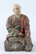 A POLYCHROME PAINTED STUCCO AND WOOD FIGURE OF A LOUHAN, late Ming / early Qing Dynasty, modelled