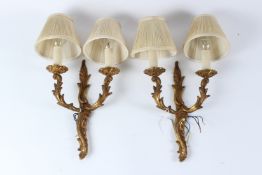 A PAIR OF ROCOCO STYLE ORMOLU TWIN-BRANCH WALL APPLIQUES, complete with shades. 30cms high x 21cms