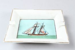 HERMES, PARIS, A PORCELAIN ASHTRAY decorated with a sailing ship. 19cms wide.