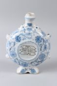 AN ISLAMIC POTTERY WATER FLASK, with blue painted floral decoration, calligraphy panels to the