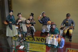 A group of six Royal Doulton figures, The Orange Lady HN1953, The Laird HN2361, The Coachman HN2282,