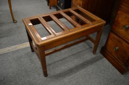 A mahogany luggage stand.
