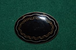 A decorative enamel brooch.