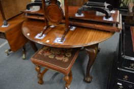 An Edwardian mahogany extending dining table with three leaves.