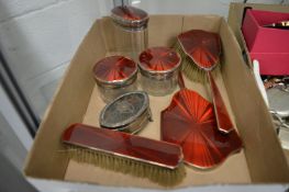 Enamel backed silver dressing table items and a silver and tortoiseshell trinket box.