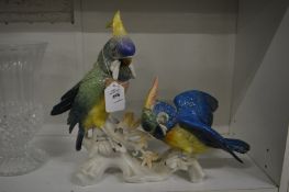 Continental porcelain model of two parrots on a branch.
