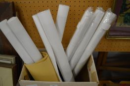 A group of unframed artwork.