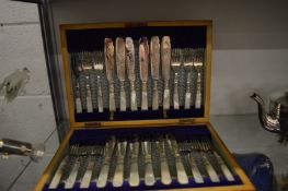 A cased set of twelve mother of pearl handled plated fish knives and forks.
