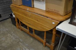 A modern oak drop leaf gateleg dining table.