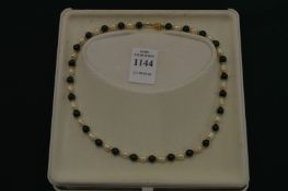 Decorative pearl and malachite necklace.