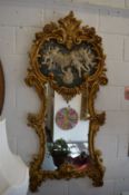 A pair of decorative ornate gilt framed pier mirrors with faux marble panels.
