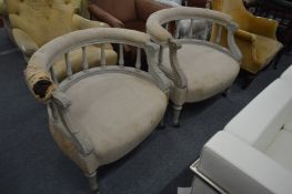 A pair of grey painted horseshoe shaped open armchairs with carved decoration.