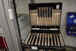 A cased set of twelve silver handled dessert knives and forks.
