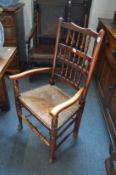 Eight Lancashire spindle back dining chairs with rush seats, two with arms.