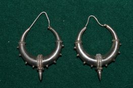 A pair of decorative earrings.