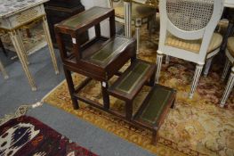 A set of reproduction mahogany and green leather inset metamorphic library steps.