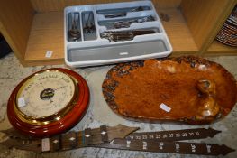 Barometer, wooden bowl, cutlery and a wooden calendar.