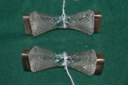 A pair of silver mounted cut glass knife rests.